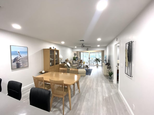 dining space featuring light wood-type flooring and ceiling fan