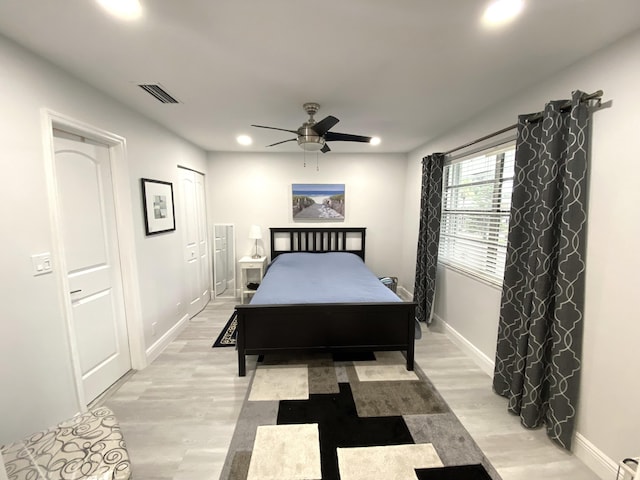 bedroom with ceiling fan and light hardwood / wood-style floors