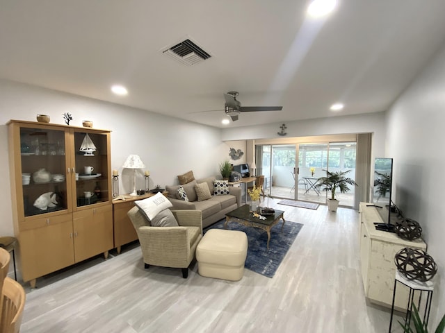 living room with ceiling fan and light wood-type flooring