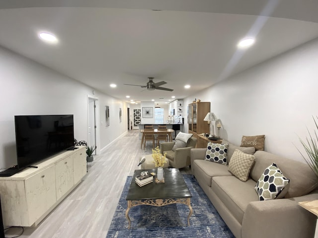 living room with ceiling fan and light hardwood / wood-style floors