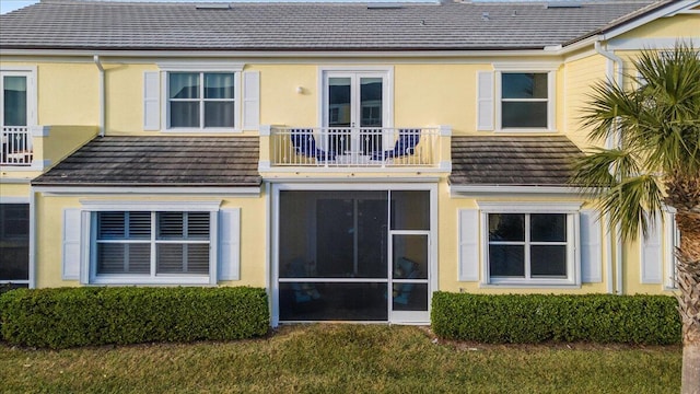 back of property with a balcony