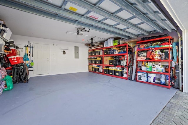 garage featuring a garage door opener and electric panel