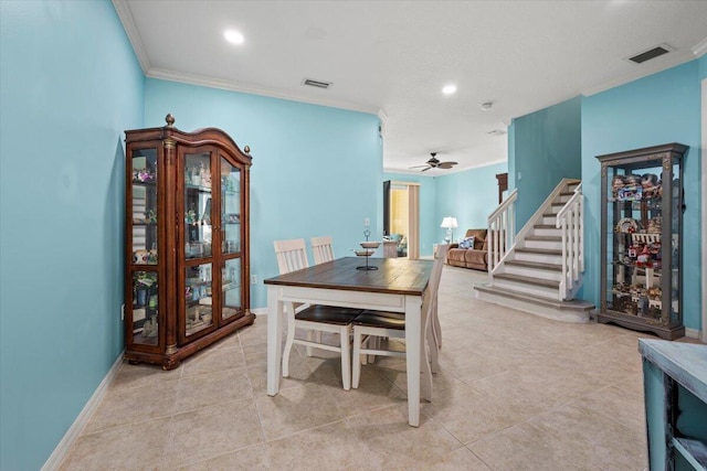 tiled dining room featuring ceiling fan and ornamental molding