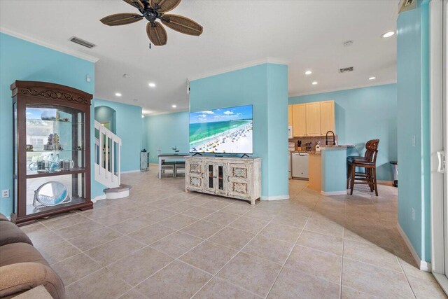 tiled living room with crown molding and ceiling fan