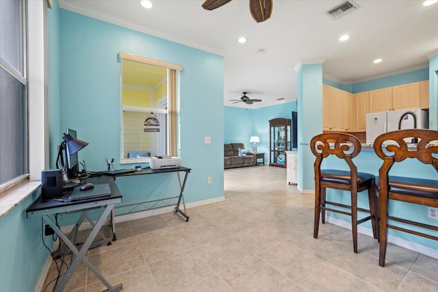 kitchen with ceiling fan, ornamental molding, light brown cabinetry, and white fridge