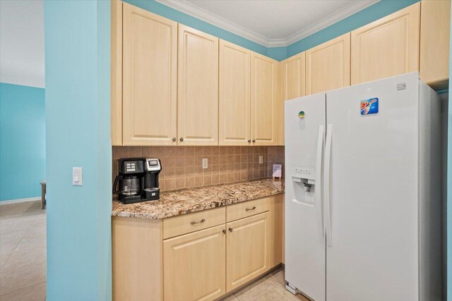 kitchen featuring a breakfast bar, ornamental molding, light stone counters, kitchen peninsula, and white appliances