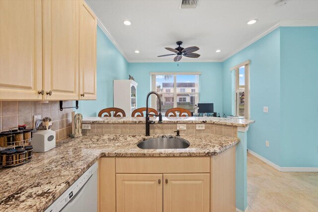 kitchen with light stone counters, white appliances, sink, and backsplash