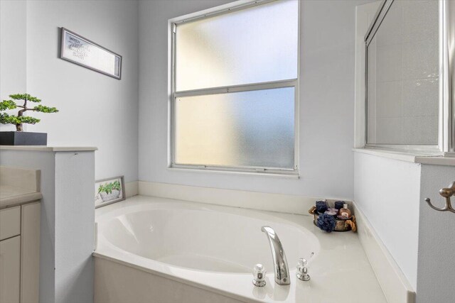 full bathroom featuring independent shower and bath, vanity, tile patterned floors, and toilet