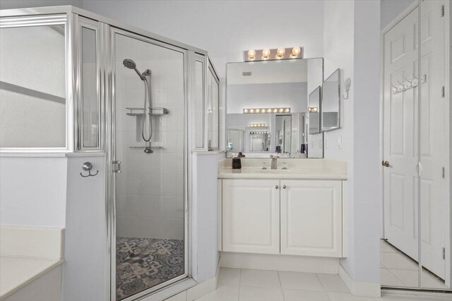 bathroom with vanity, tile patterned floors, and independent shower and bath