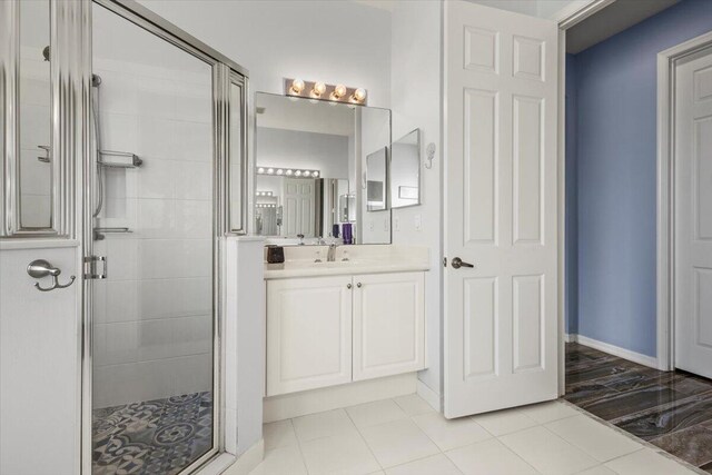 bathroom with walk in shower, tile patterned floors, and vanity