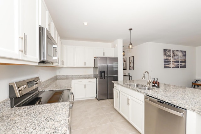 kitchen featuring white cabinetry, stainless steel appliances, decorative light fixtures, and sink