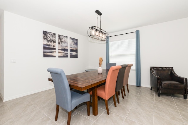 dining area with light tile patterned floors and a chandelier