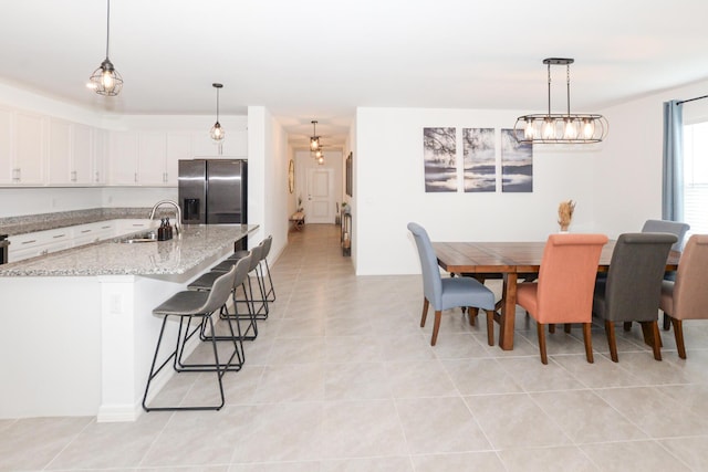 tiled dining room with sink