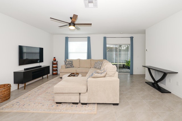 living room with ceiling fan, light tile patterned floors, and a wealth of natural light