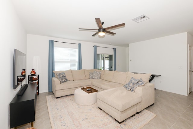 living room featuring ceiling fan and light tile patterned floors