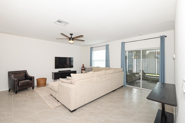 living room featuring light tile patterned floors and ceiling fan