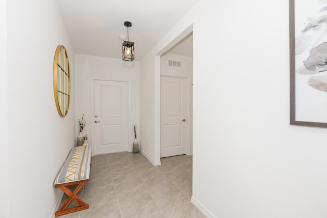 hall featuring light tile patterned floors