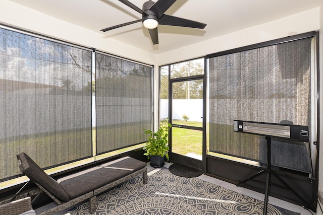 sunroom / solarium featuring ceiling fan