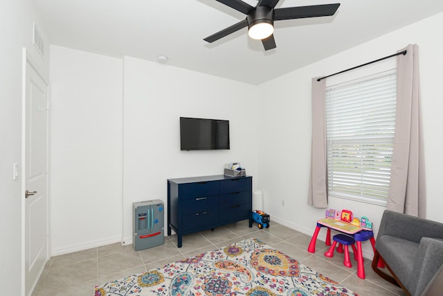 recreation room with light tile patterned flooring and ceiling fan