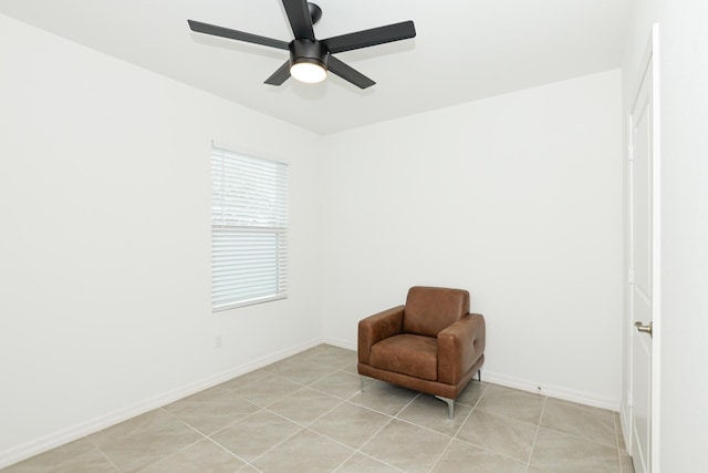 living area with ceiling fan and light tile patterned floors