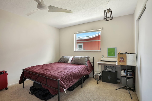 bedroom with light carpet, a textured ceiling, and ceiling fan