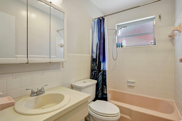 full bathroom featuring vanity, tile walls, shower / bathtub combination with curtain, and toilet