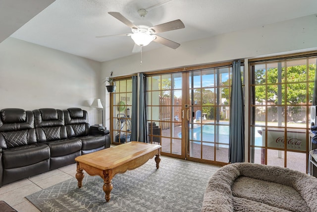 tiled living room featuring a wealth of natural light and ceiling fan