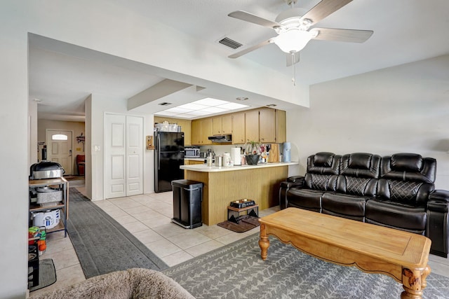 tiled living room featuring ceiling fan