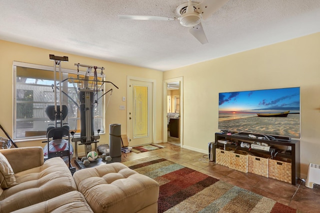 tiled living room featuring ceiling fan and a textured ceiling