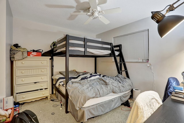 bedroom featuring ceiling fan, light colored carpet, and a textured ceiling