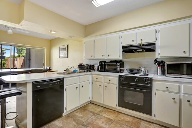 kitchen with sink, a breakfast bar area, black appliances, white cabinets, and kitchen peninsula