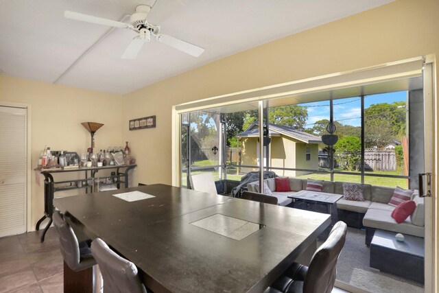 tiled dining room featuring ceiling fan