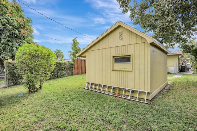 view of outbuilding featuring a yard