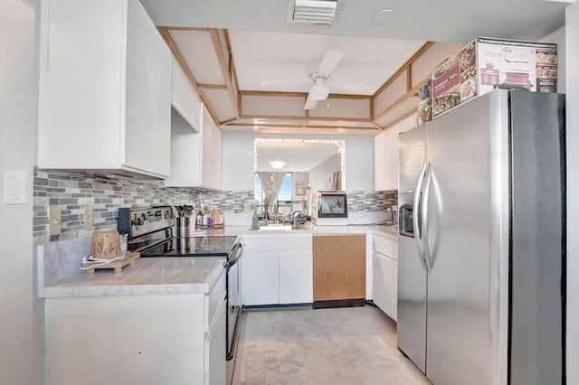 kitchen with ceiling fan, backsplash, appliances with stainless steel finishes, and white cabinetry