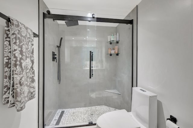 bathroom featuring toilet and an enclosed shower