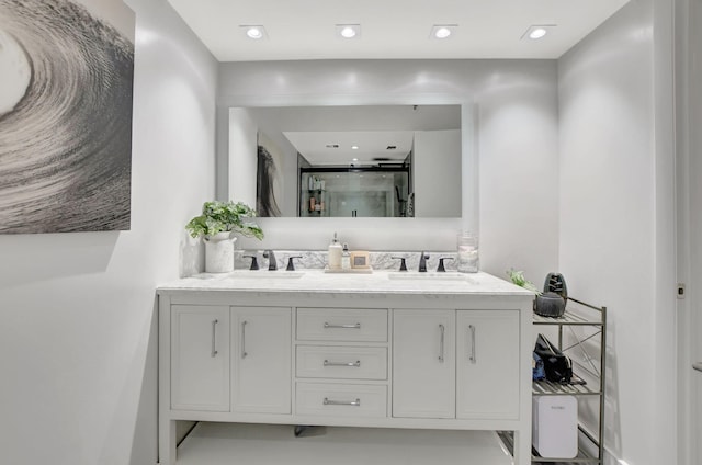 bathroom featuring walk in shower and vanity