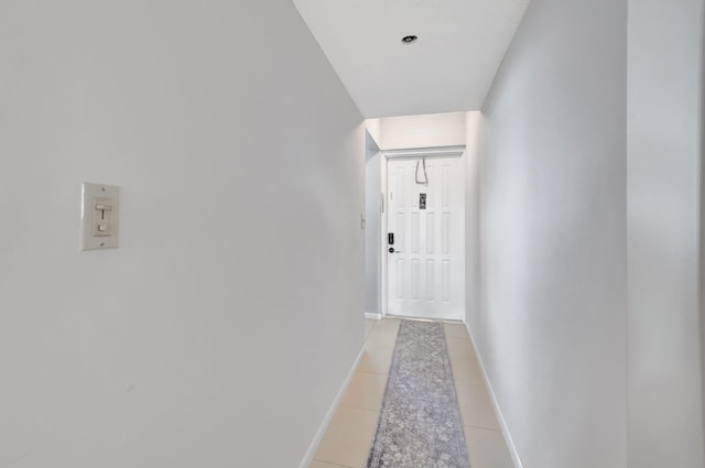 hall featuring light tile patterned flooring