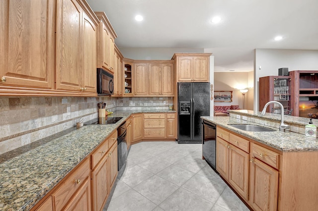 kitchen featuring black appliances, decorative backsplash, sink, light tile patterned flooring, and light stone counters