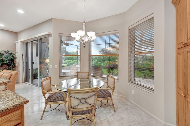 dining area featuring light tile patterned flooring and an inviting chandelier