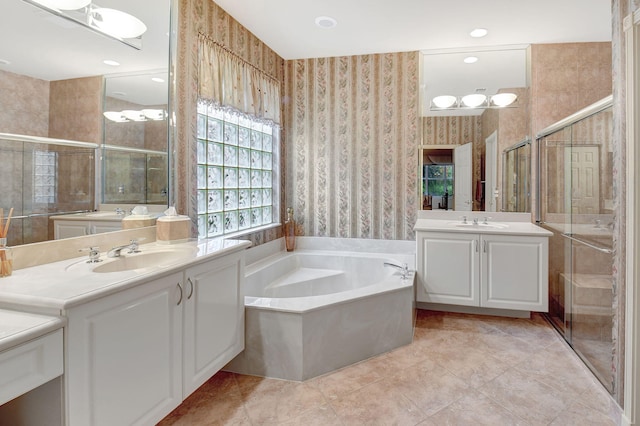 bathroom featuring independent shower and bath, tile patterned floors, and vanity