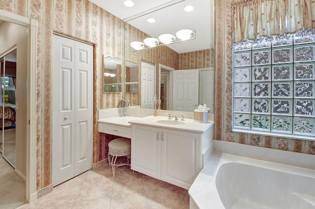 bathroom featuring vanity, tile patterned floors, and a bathing tub