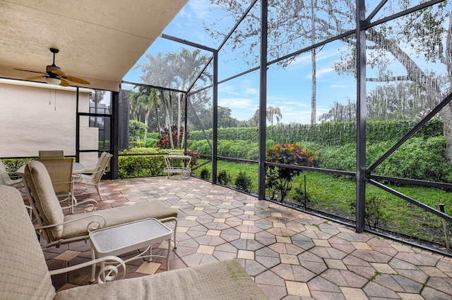 unfurnished sunroom featuring ceiling fan