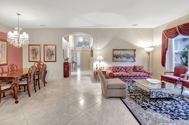 tiled living room featuring a chandelier