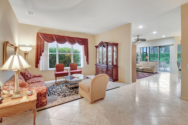 living room featuring ceiling fan, a healthy amount of sunlight, and light tile patterned floors