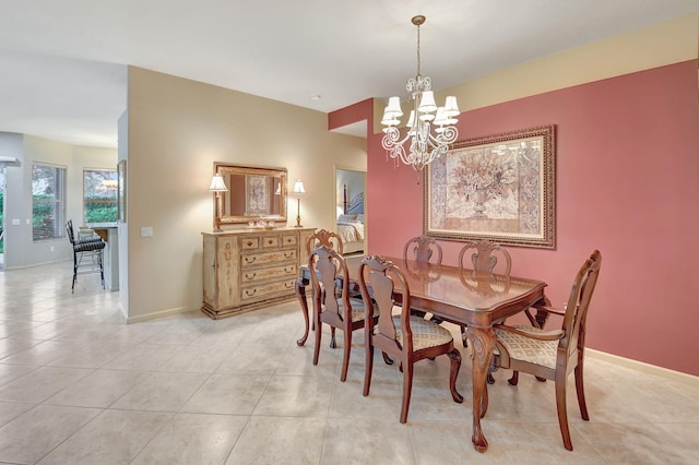 dining room with light tile patterned floors and a chandelier