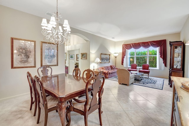 dining room with light tile patterned flooring and an inviting chandelier