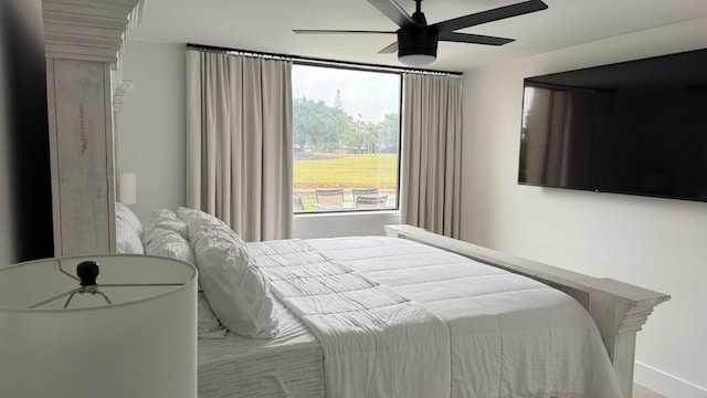 bedroom with ceiling fan and multiple windows