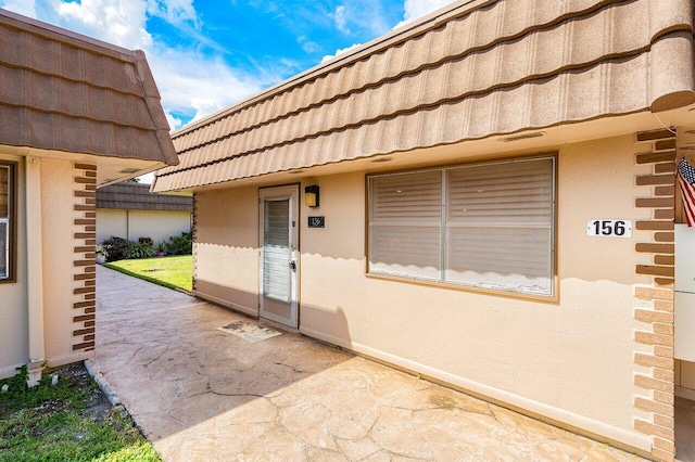 property entrance featuring a patio area