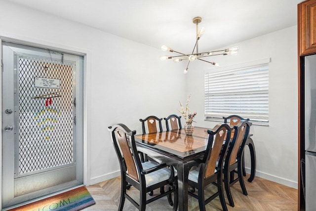 dining area featuring light parquet floors and a chandelier