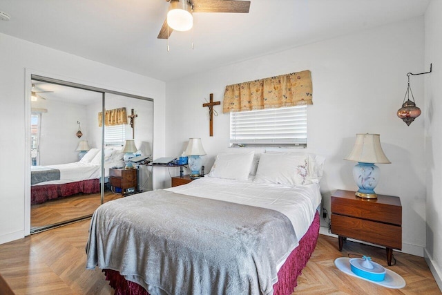 bedroom featuring ceiling fan, light parquet flooring, and a closet